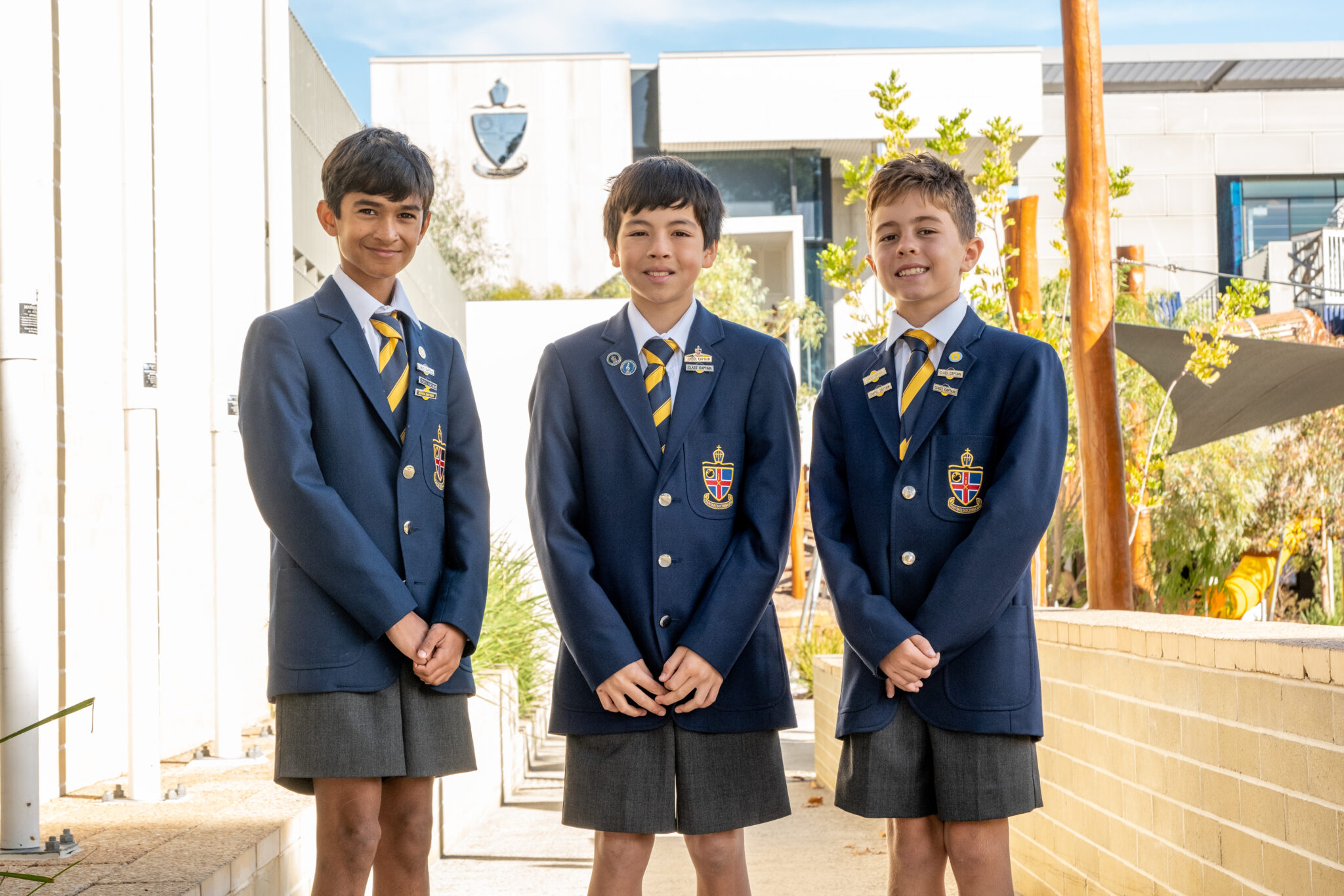 Three Preparatory students standing tall and smiling