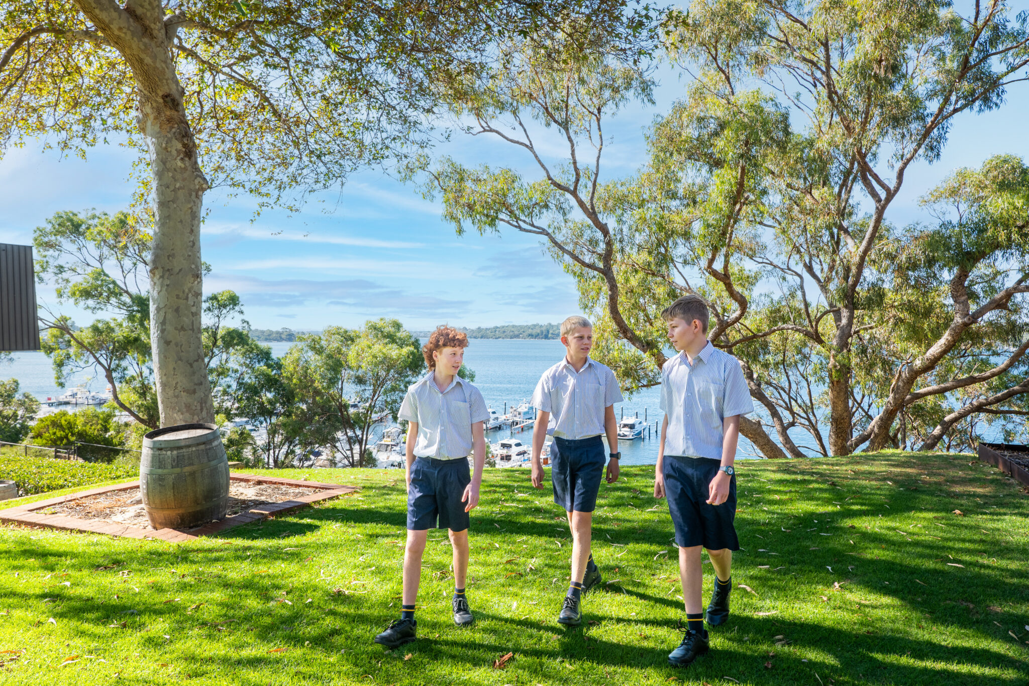 Three boarding students walking on Walters Lawn