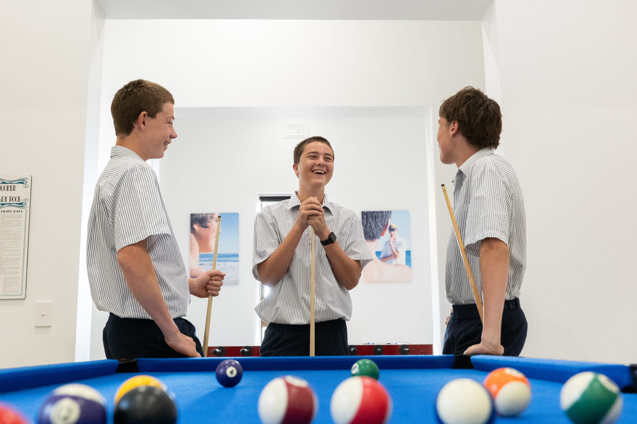 Three boarding students playing pool in Walters Boarding House