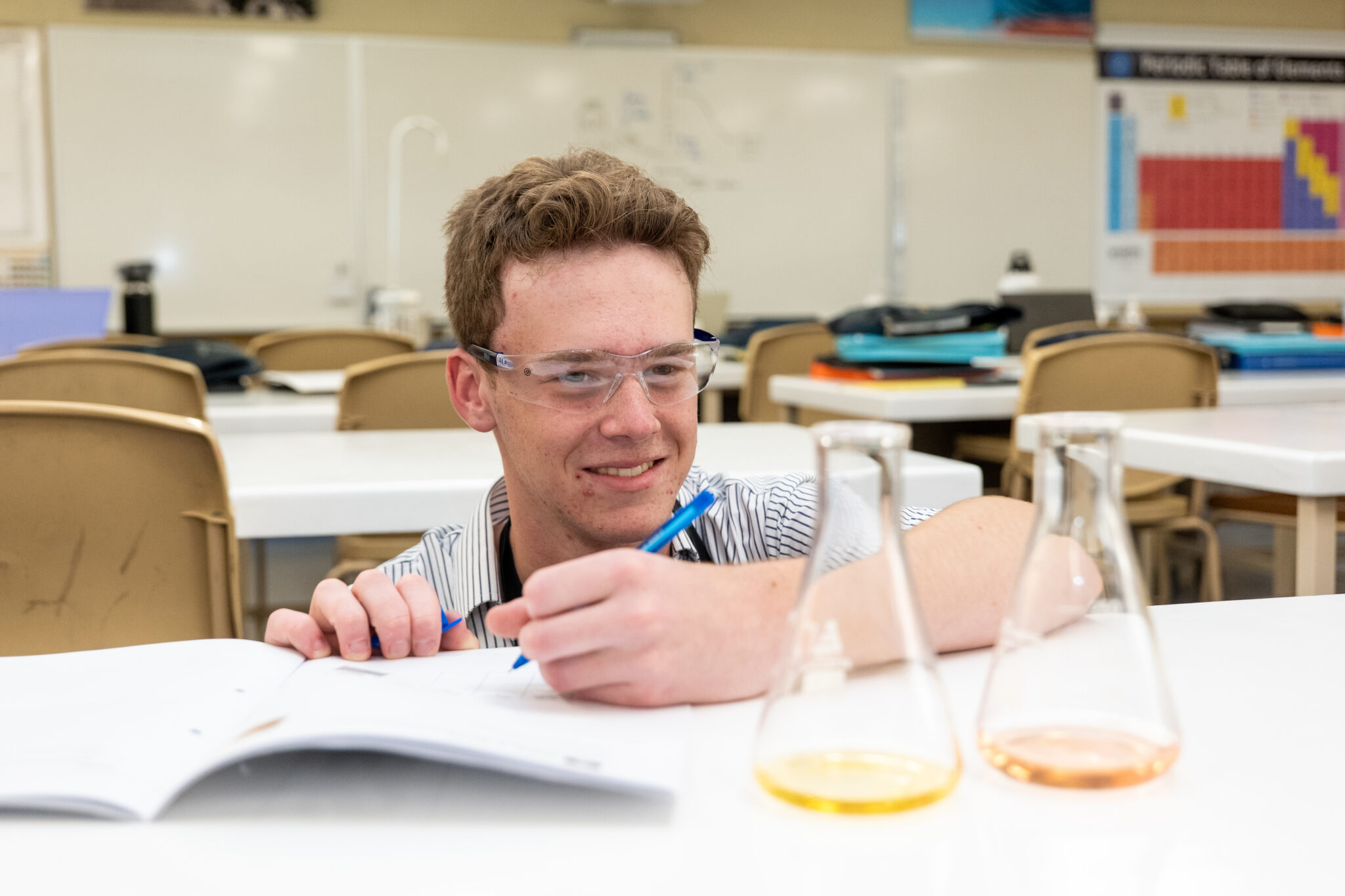 Senior School student examines a chemistry experiment
