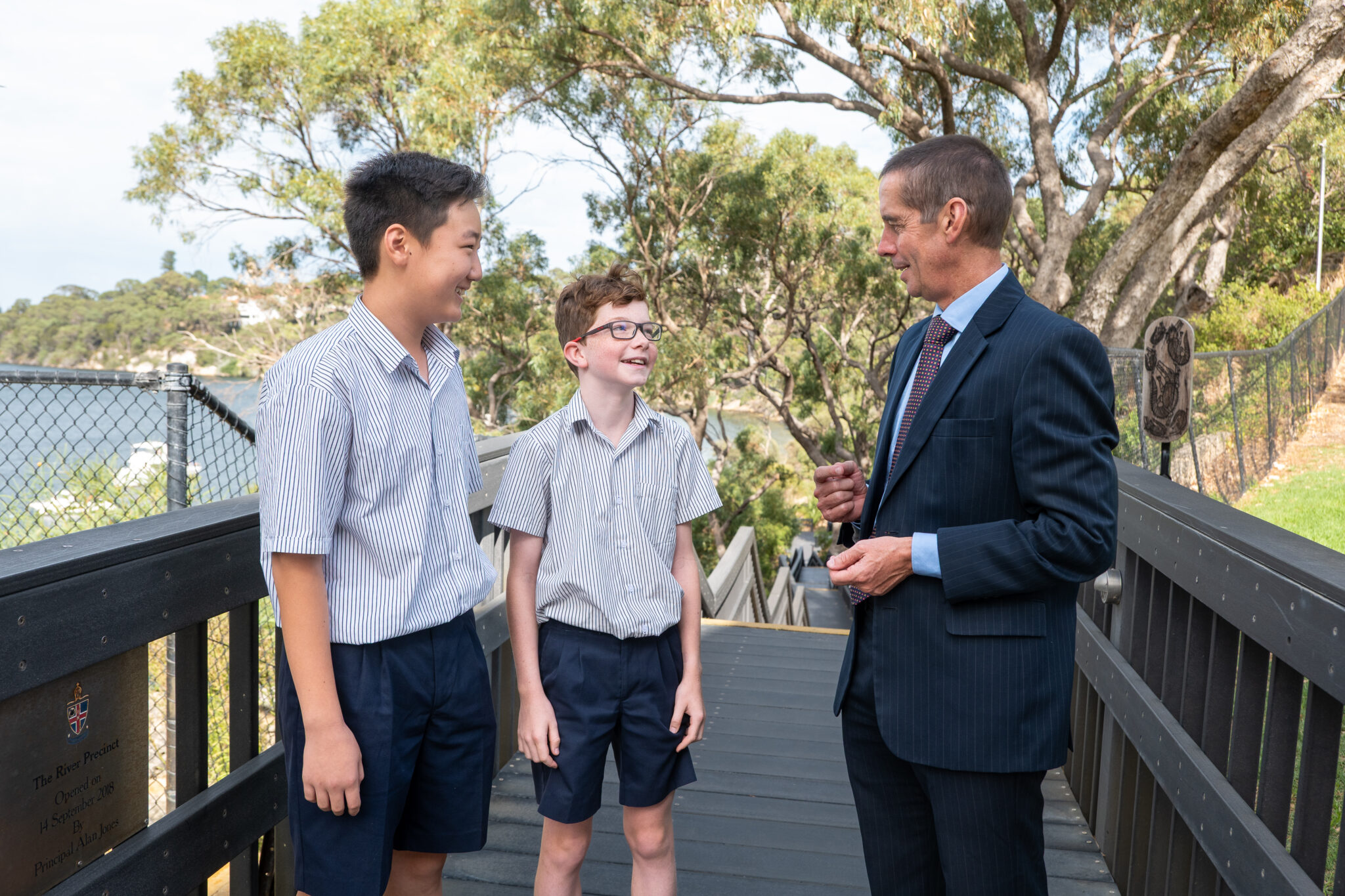 Two student speaking with Principal Alan Jones