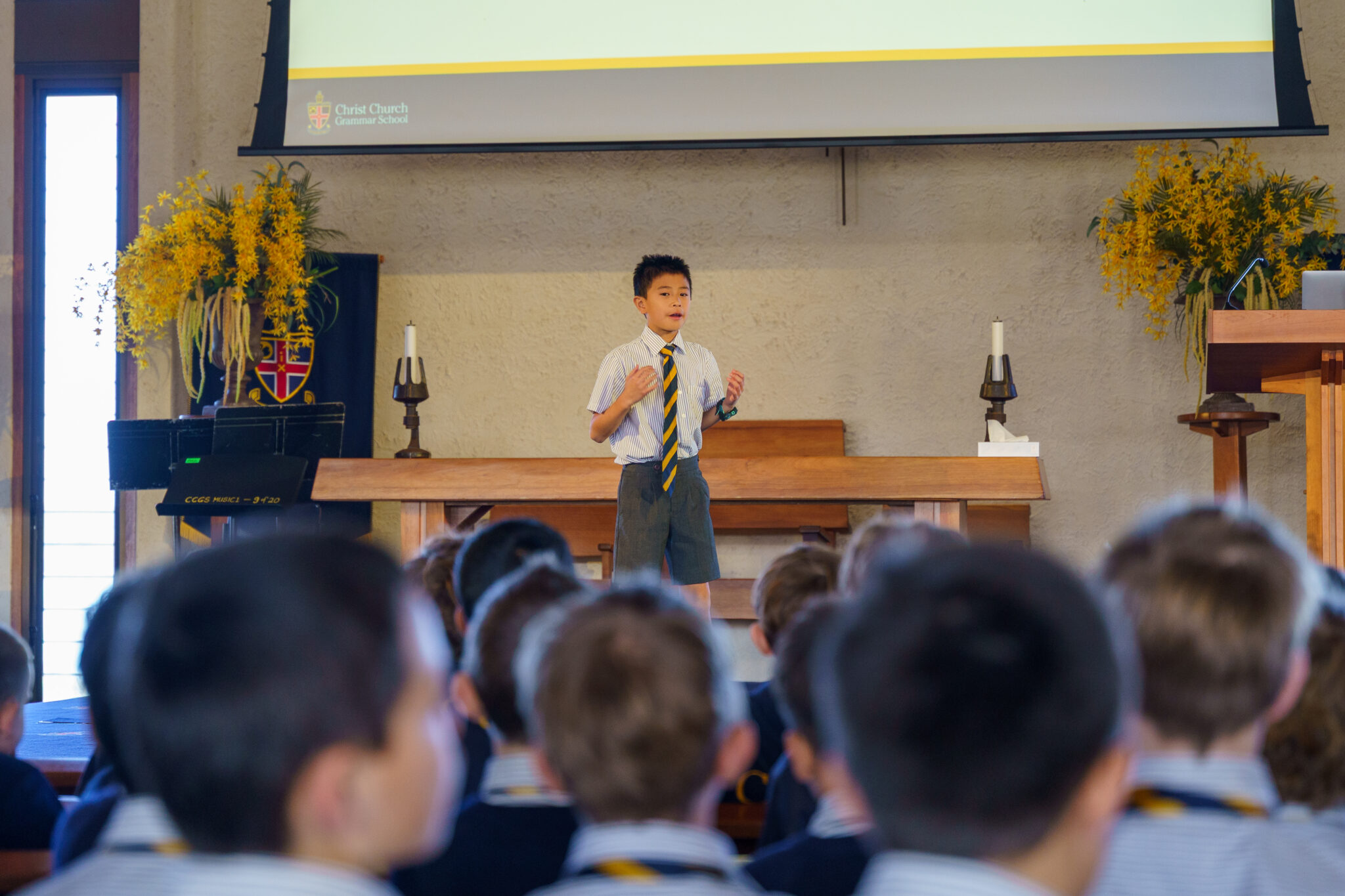 A student delivering a speech to fellow students in Chapel for Speakers