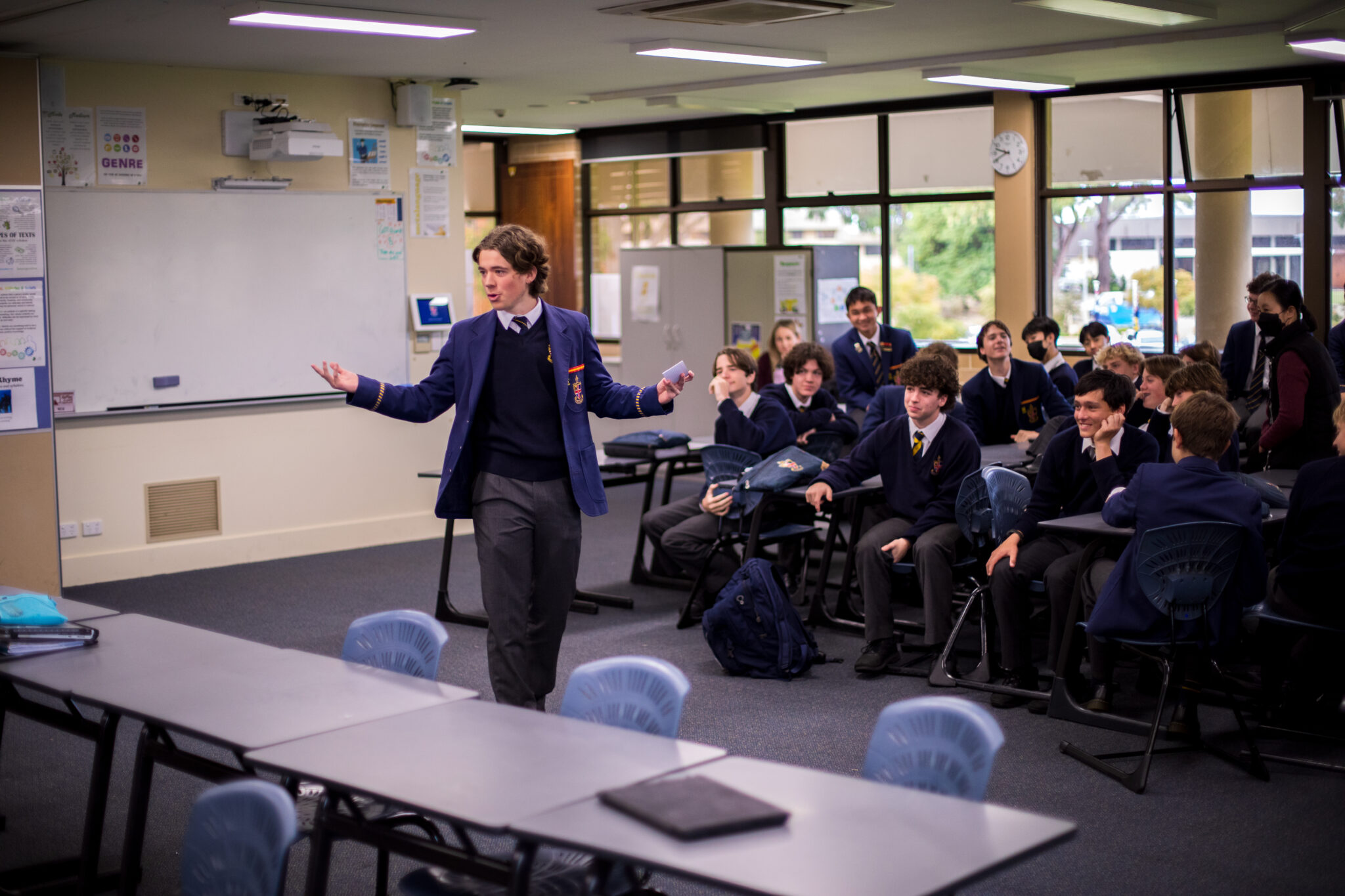 A senior school student addressing a classroom of students during the House Arts Competition. The student is competing in public speaking
