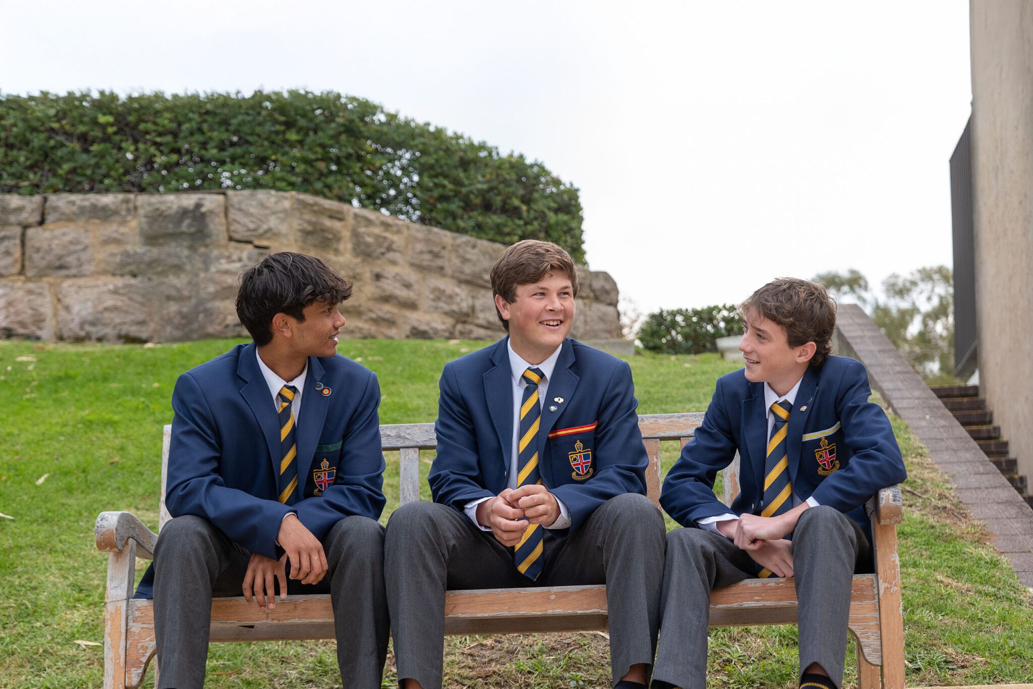 Boarding students sitting on a bench having a conversation