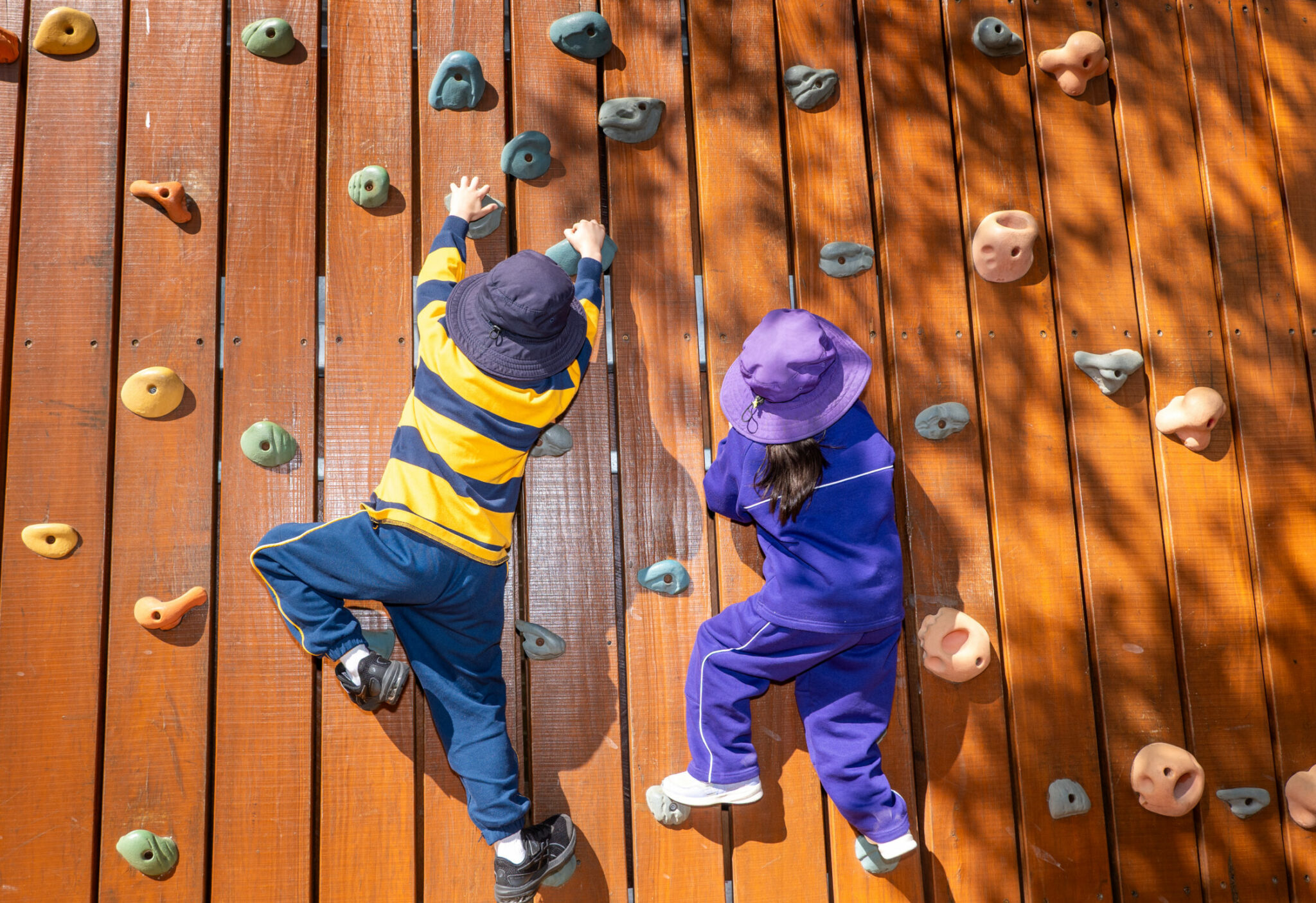 Climbing on rock wall - play dates with girls schools