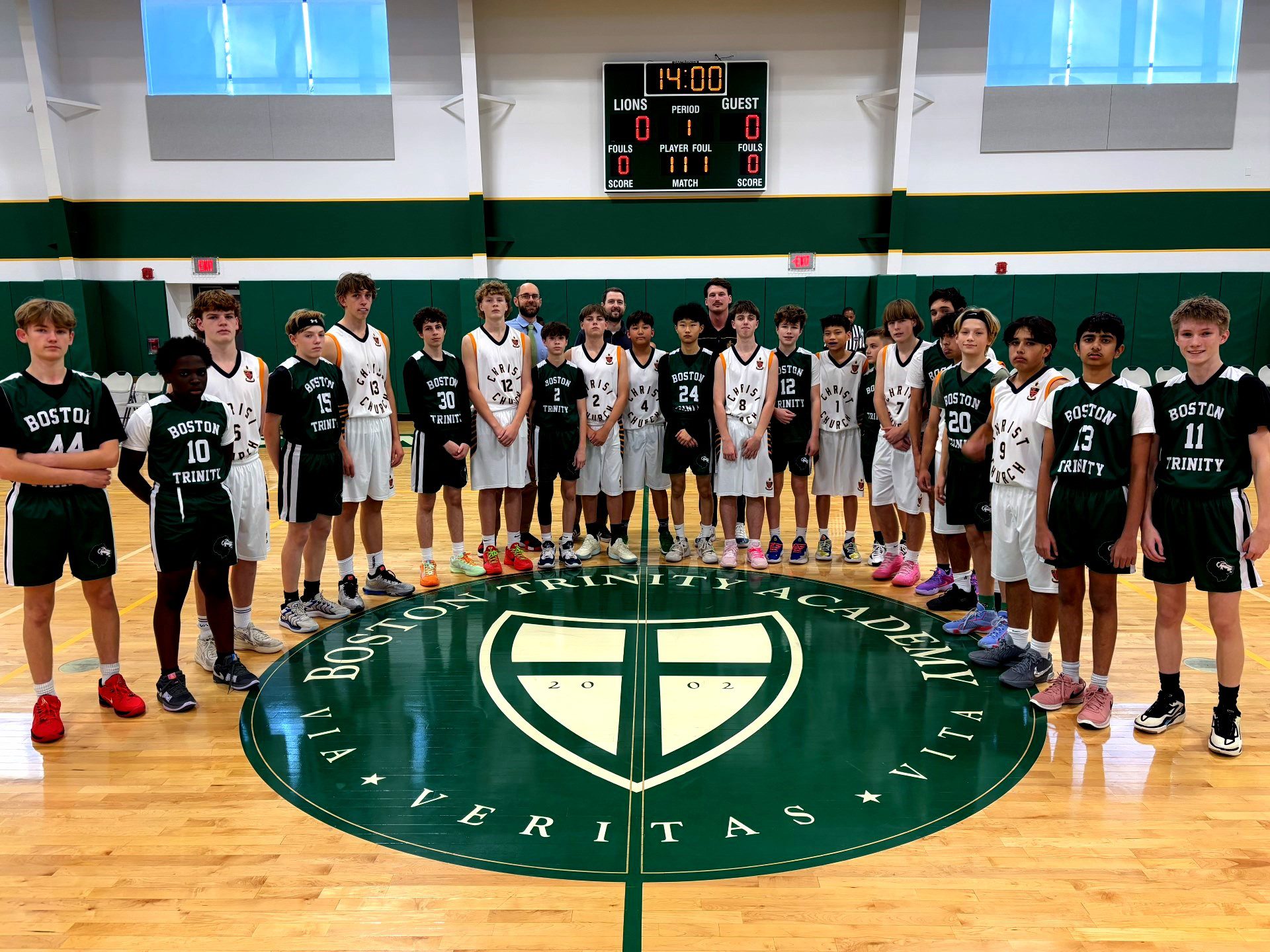 Students on a basketball court with their counterparts from Boston Trinity Academy