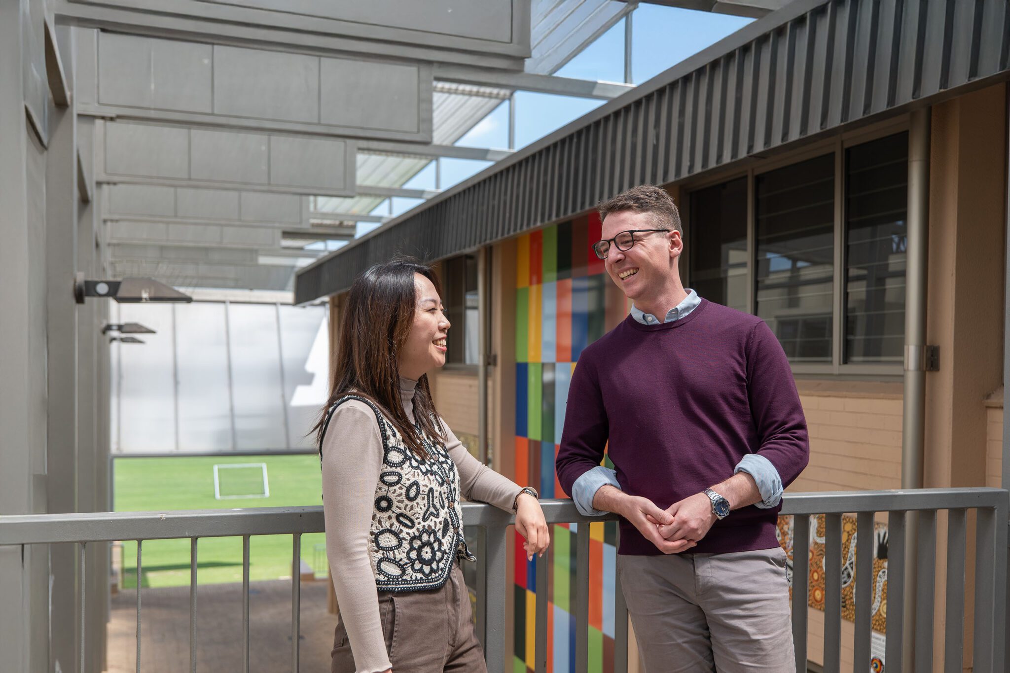 Two Senior School teachers smiling and talking