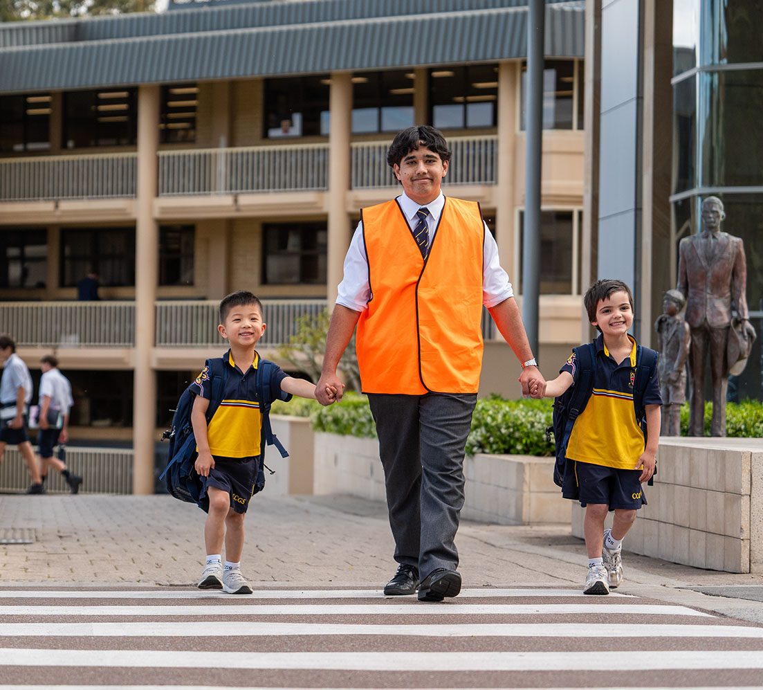 Prefect escorting ELC students across the carpark