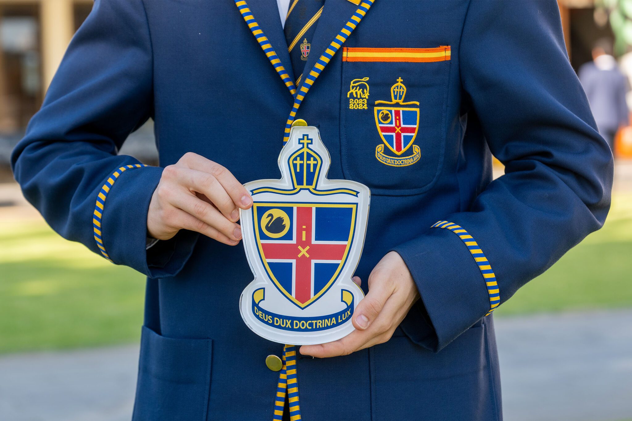 Student holding the crest