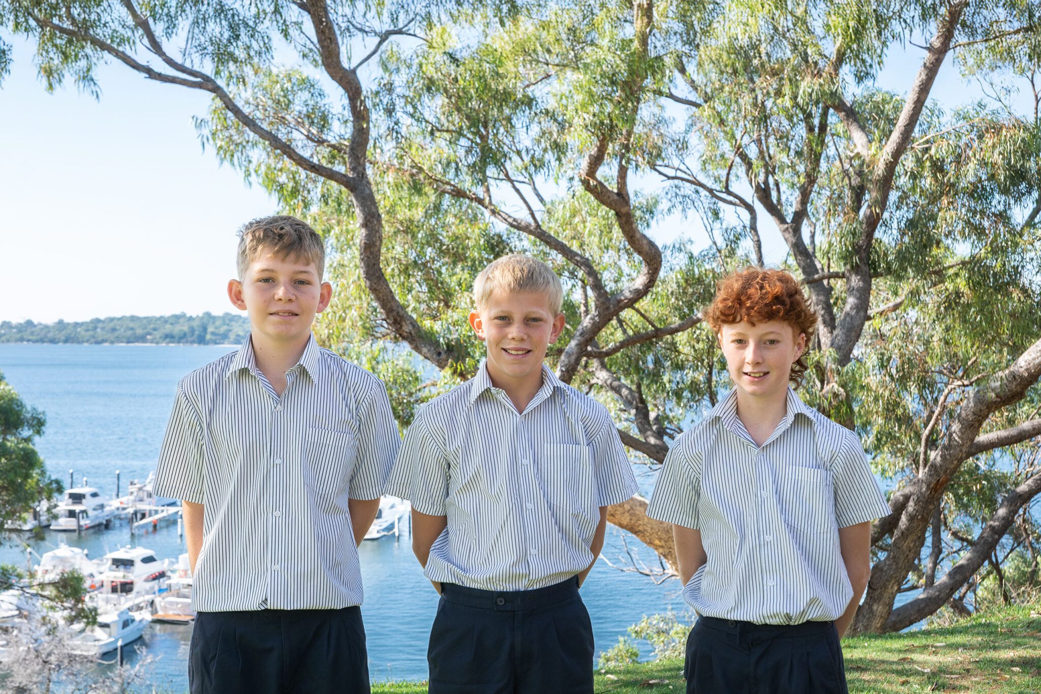 Senior School students standing on the Walters House lawn overlooking Swan River
