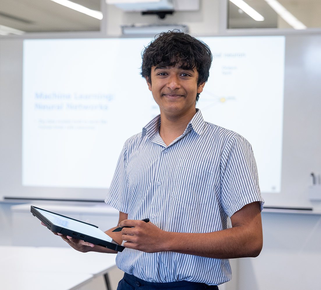 Student working in class with device