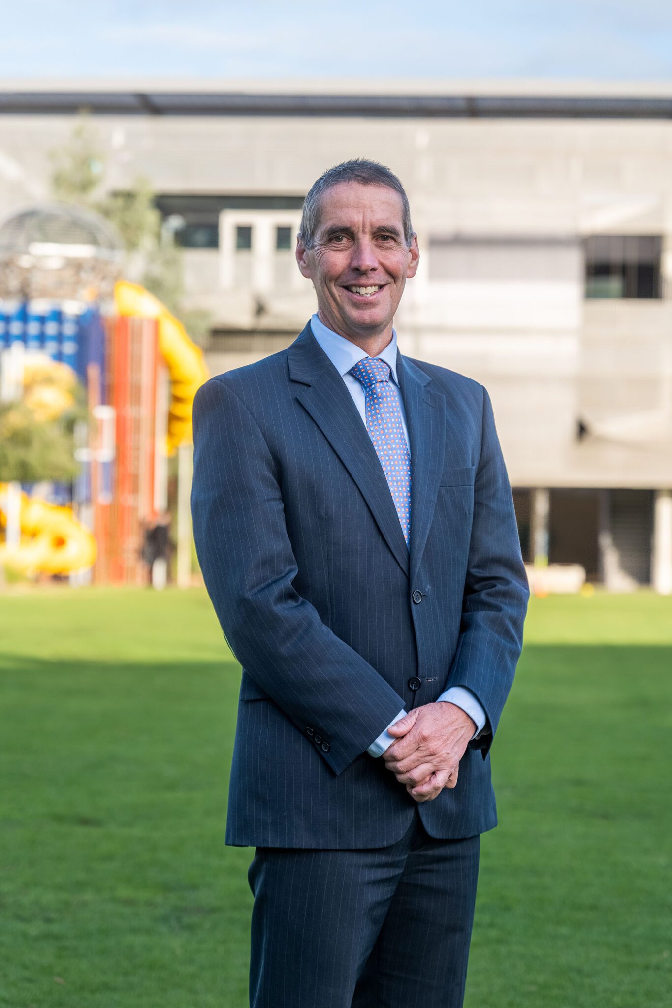 Principal Alan Jones standing on the Preparatory School oval