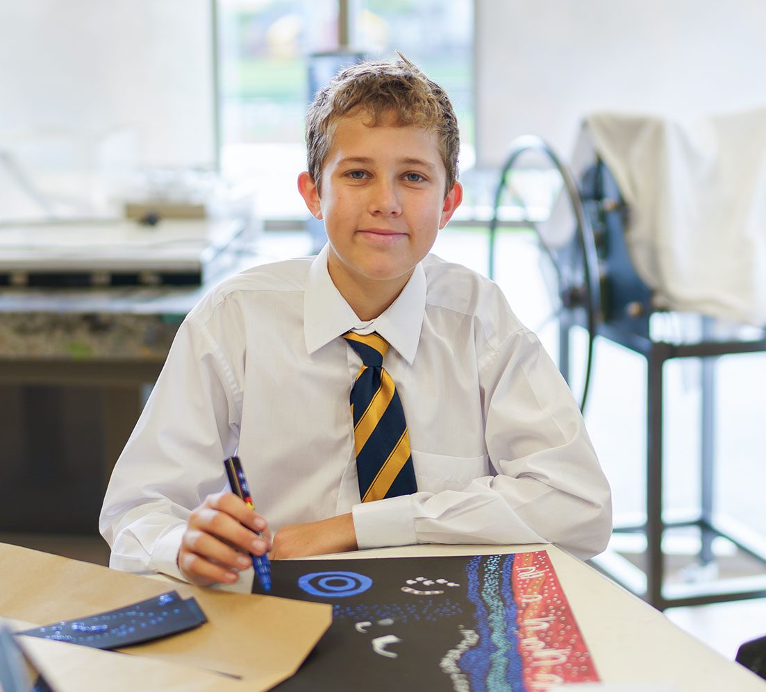 A student painting during an art class